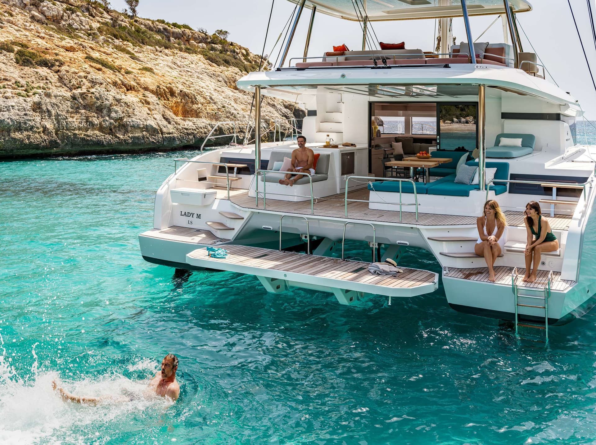 lagoon 55 nomad lifestyle people swimming water back boat crewed