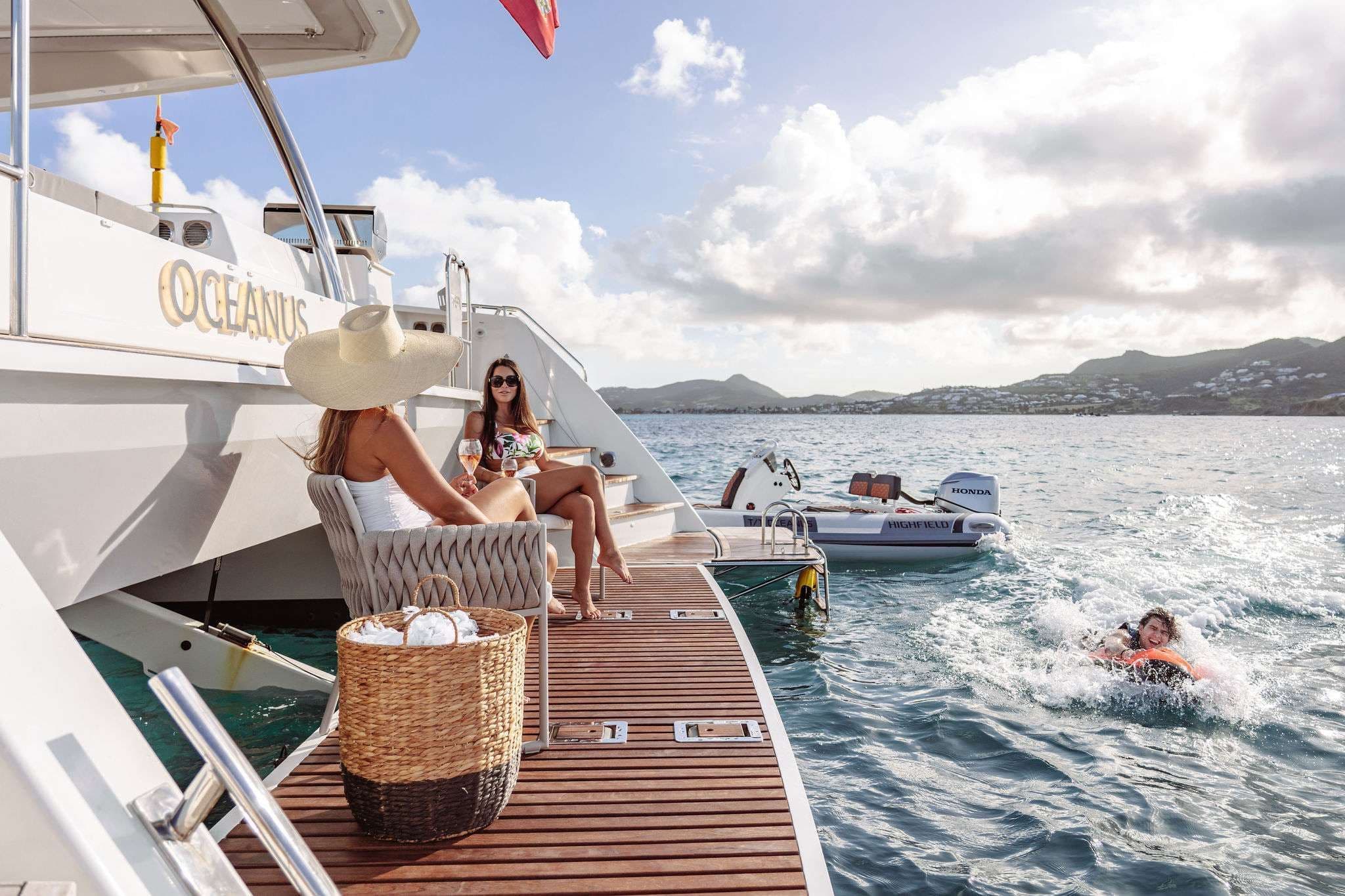 fountaine pajot 70 oceanus crewed catamaran people relaxing swim platform
